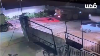 "Israeli" occupation armored vehicle running over a young Palestinian man after murdering him