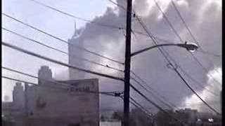View from NJ, towers burning, people gathered watching and...