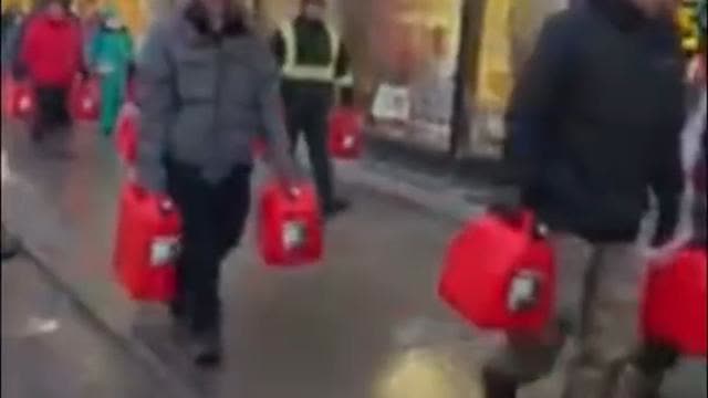 Ottawa residents carry empty gas cans to throw off police
