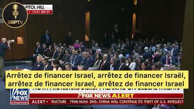 A protester shouts "The greatest threat to global security is Israel and the whole world knows it"