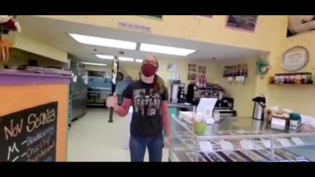 This grocery store threatens non-masked people with a baseball bat