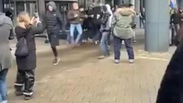 Police agitators get found out at an anti covid lockdown protest in Amsterdam.