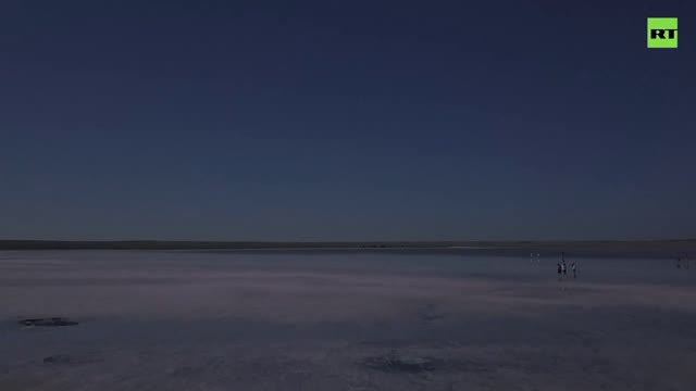 Tourists rush to Kazakhstanâ€™s pink lake in belief that its salt helps to fight COVID