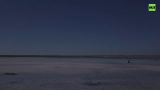 Tourists rush to Kazakhstanâ€™s pink lake in belief that its salt helps to fight COVID